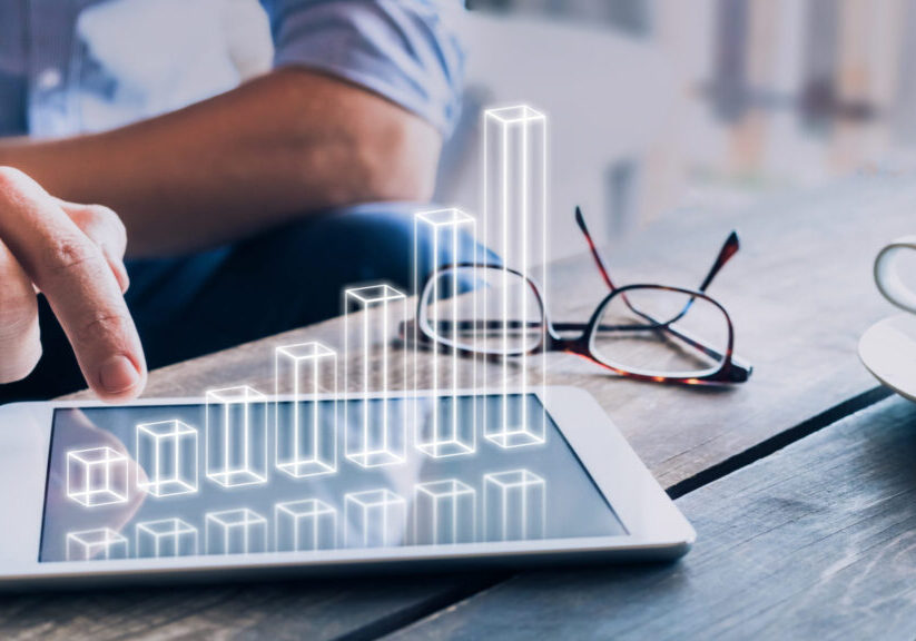 Businessman analyzing growing 3D AR chart floating above digital tablet computer screen, showing successful increase in business profit